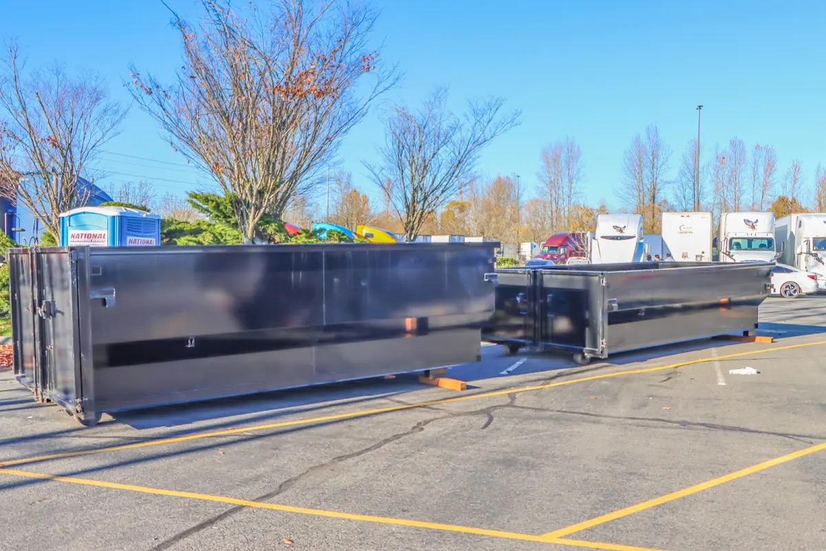 Professional dumpster rental service with roll-off container on residential driveway in Longboat Key